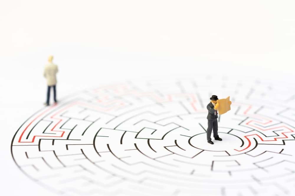 miniature-people-businessman-labyrinth-maze-figuring-out-way-out.jpg